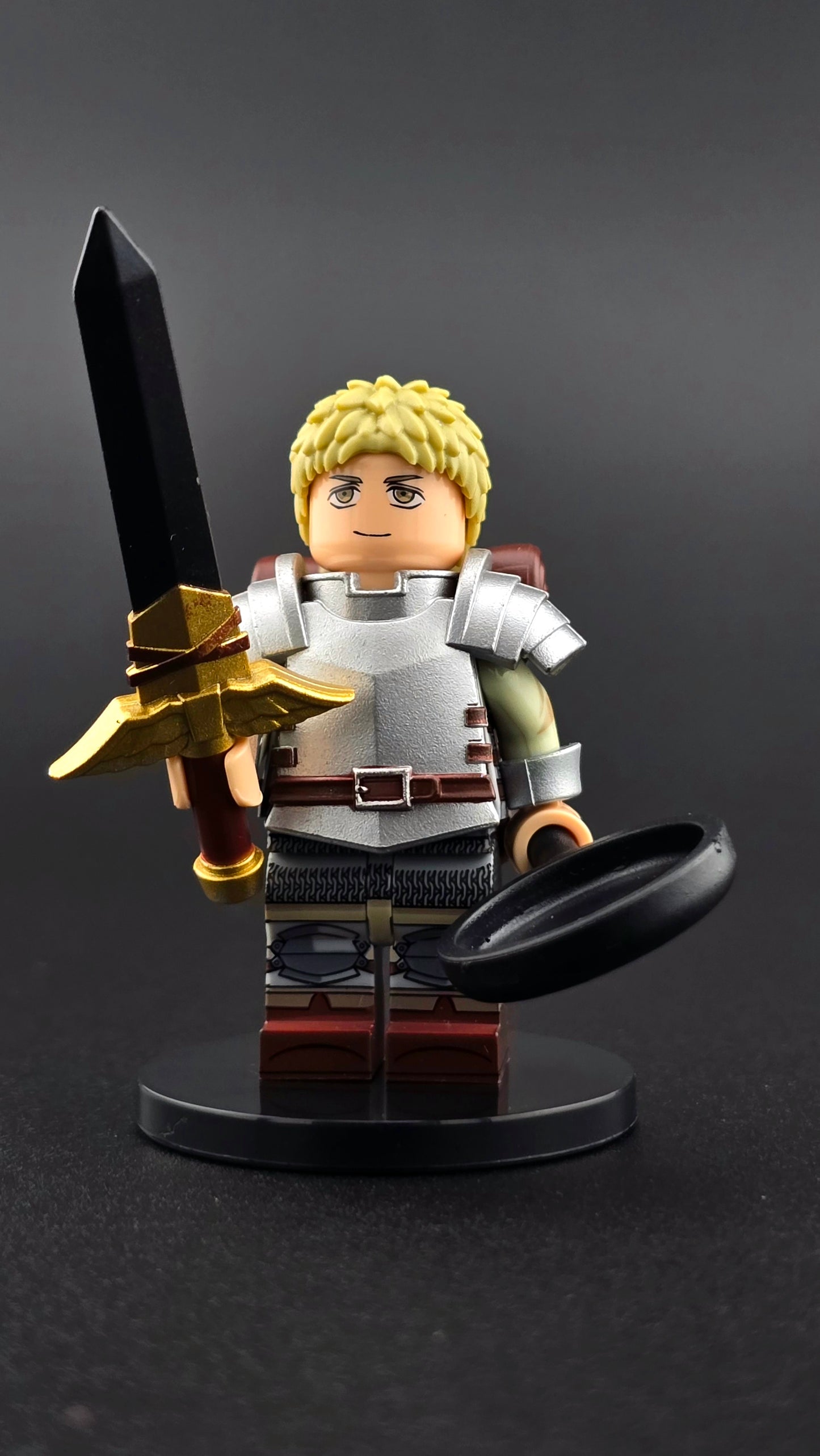 Custom anime inspired Laios minifigure with metallic armor, blonde hair, dual sided head, sword, frying pan, spatula, and backpack. Detailed adventurous design compatible with leading brick style building sets.