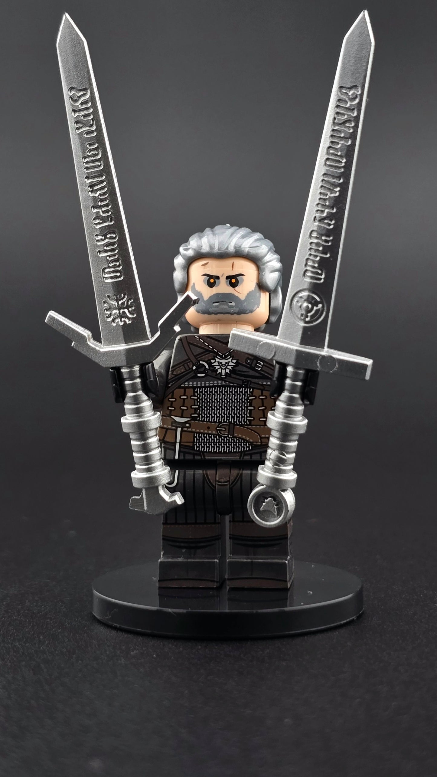 Custom gaming inspired Geralt minifigure with black, grey, and brown outfit, glowing eyes, and dual swords. Detailed monster hunter design compatible with leading brick style building sets.