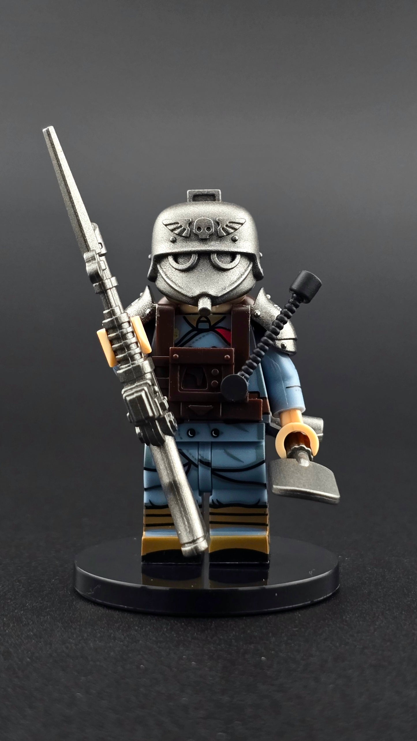 Custom sci fi inspired Krieg Soldier minifigure with blue and silver armor, gasmask helmet, rifle, and shovel. Detailed dystopian infantry design compatible with leading brick style building sets.