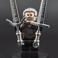 Custom gaming inspired Geralt minifigure with black, grey, and brown outfit, glowing eyes, and dual swords. Detailed monster hunter design compatible with leading brick style building sets.