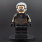 Custom gaming inspired Geralt minifigure with black, grey, and brown outfit, glowing eyes, and dual swords. Detailed monster hunter design compatible with leading brick style building sets.
