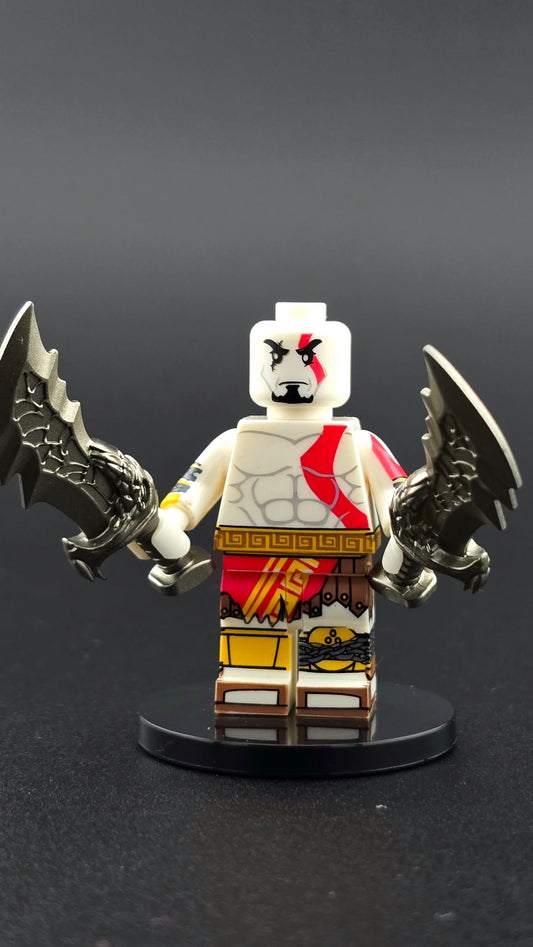 Custom gaming inspired Kratos minifigure in grey and red with muscular build, red tattoo, and dual blades. Detailed ancient Greek warrior design compatible with leading brick style building sets.