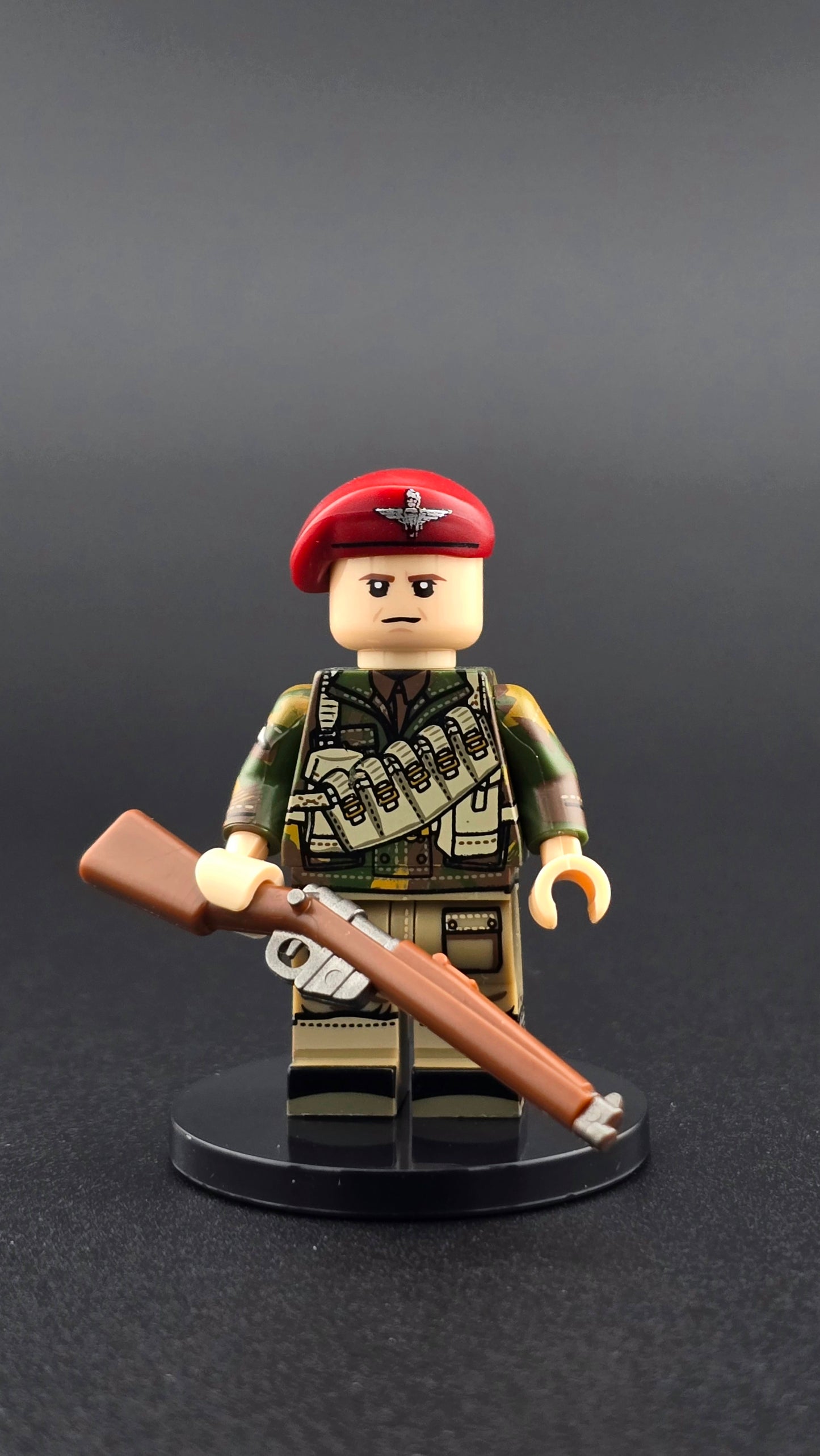 Custom WW2 British Red Devil Paratrooper minifigure featuring green camouflage uniform, red beret, and detailed printing, displayed with rifle accessory and compatible with leading brick-style sets.