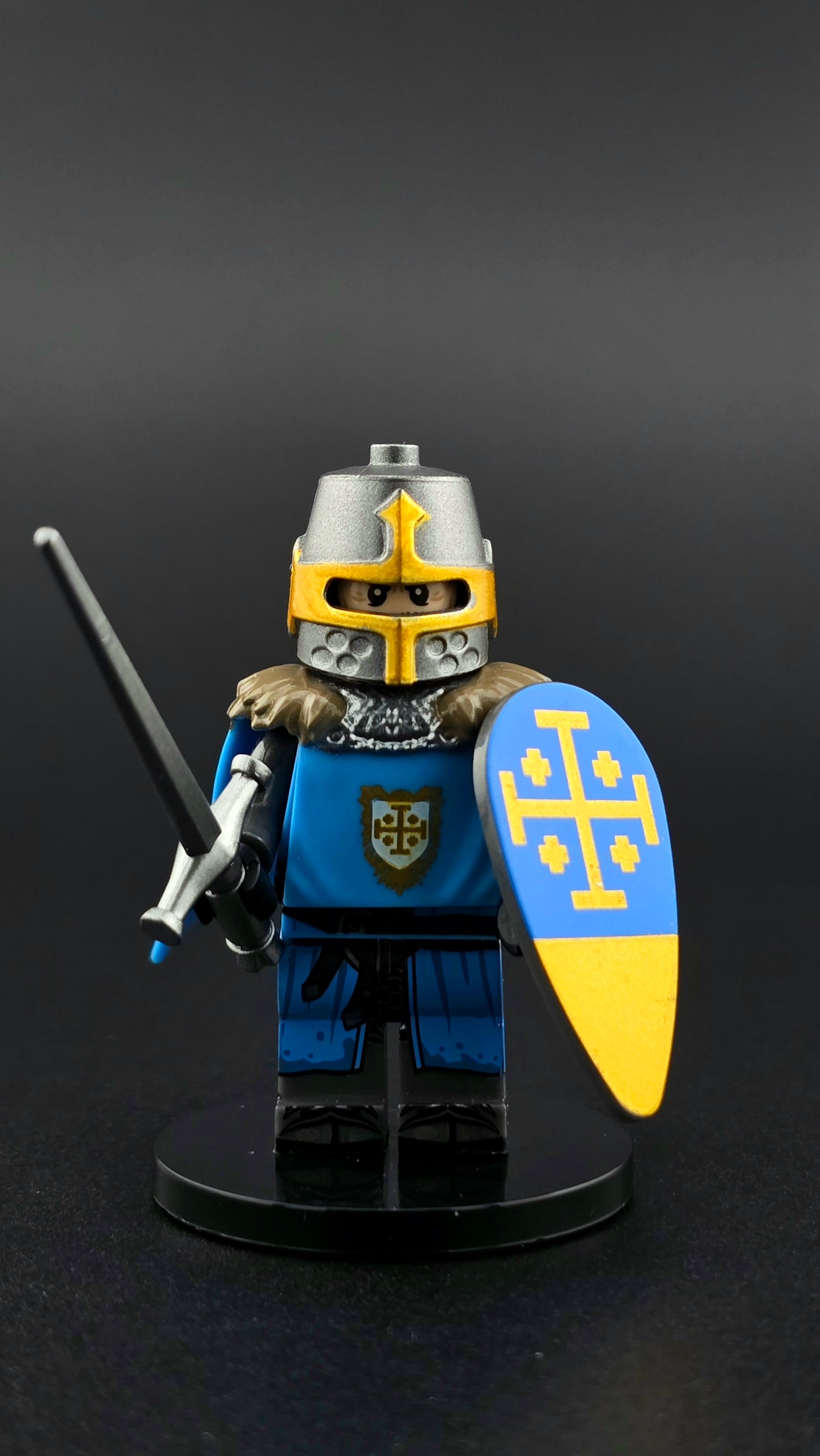 Custom medieval Jerusalem Knight minifigure in blue, white, and silver armor with great helmet and flowing cape, equipped with sword and shield accessories, compatible with leading brick-style building systems.
