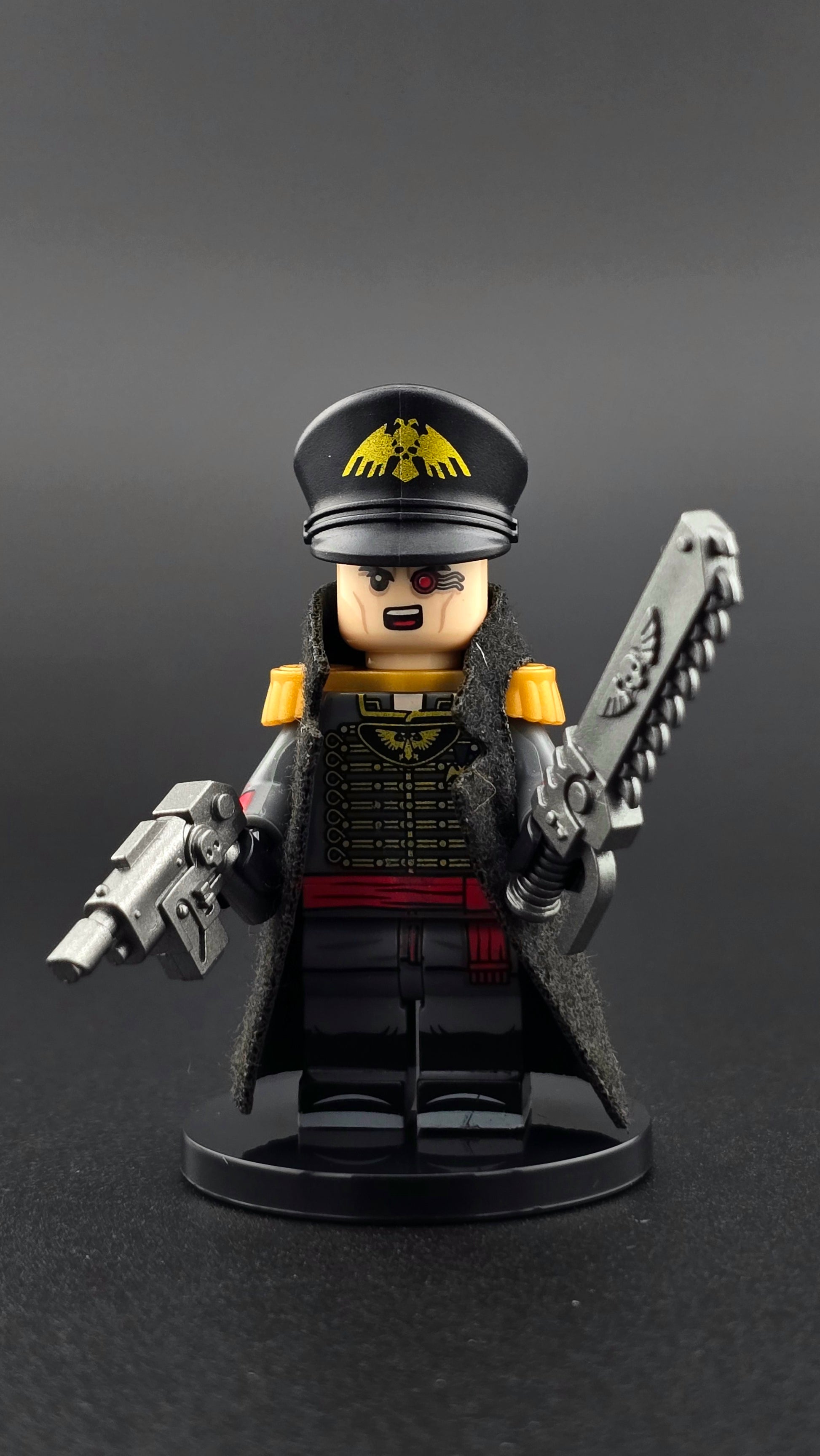 Custom sci fi inspired Commisar minifigure with black and gold uniform, cape, shouting expression, ripper blade, and pistol. Detailed futuristic officer design compatible with leading brick style building sets.
