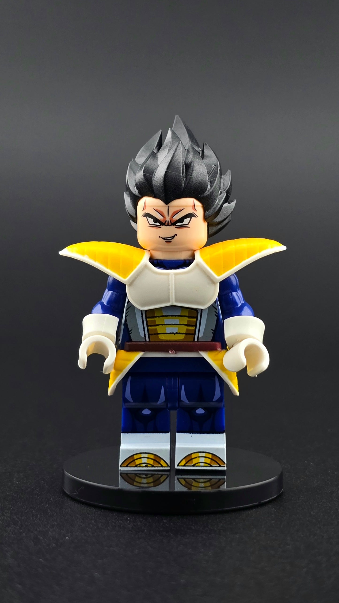 Custom anime inspired Vegeta minifigure in blue, white, and yellow armor with iconic hair and smirking expression. Detailed fighter themed design compatible with leading brick style building sets.