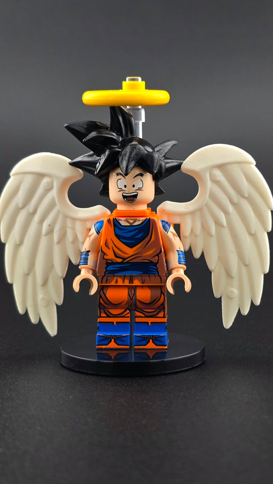 Custom anime inspired Goku minifigure in orange and blue with spiky hair, white wings, halo, and cheerful expression. Detailed celestial fighter design compatible with leading brick style building sets.