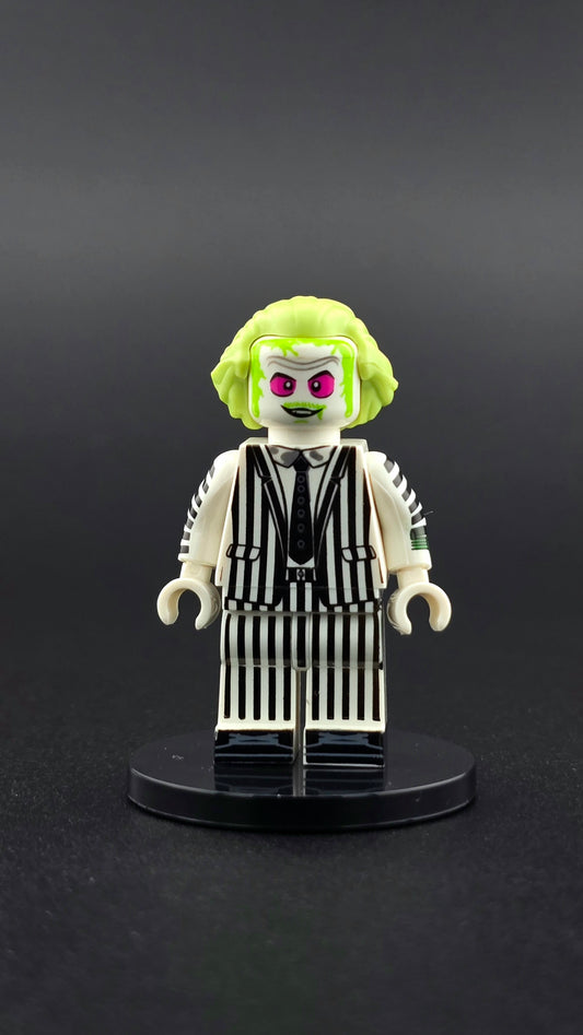 Custom Beetlejuice inspired minifigure with white and neon green details, creepy expression, and undead styling. Designed for horror and supernatural themed displays and compatible with leading brick style building sets.