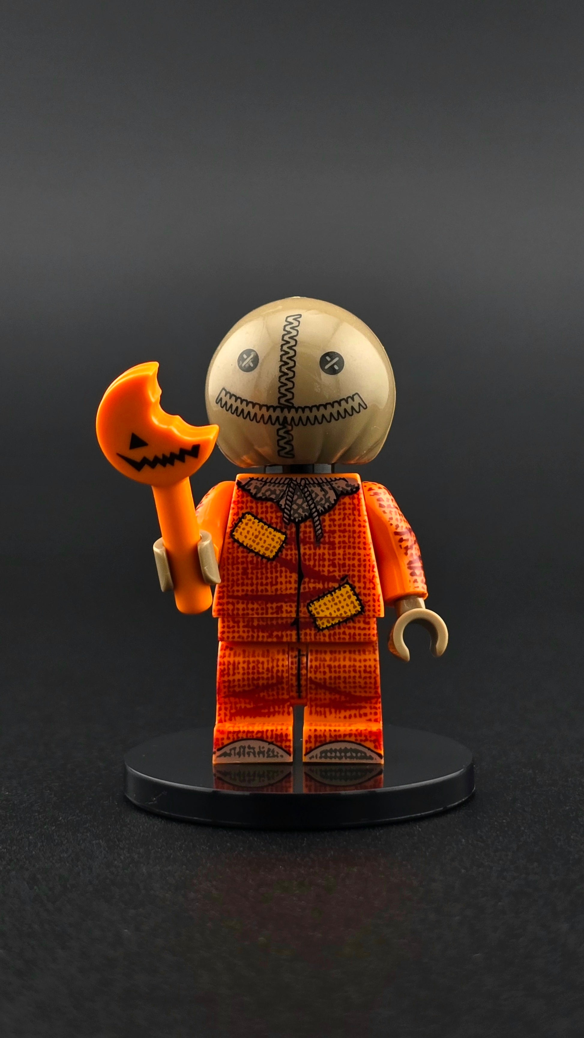 Custom Halloween inspired minifigure with orange ragged scarecrow design, stitched details, and candy cane accessory. Detailed spooky themed figure compatible with leading brick style building sets.