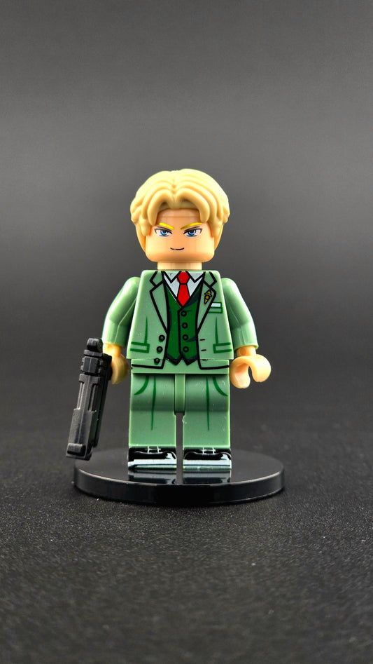 Custom anime-inspired Loid Forger minifigure wearing a green suit with a handgun accessory and dual-sided head, based on Spy X Family and compatible with leading brick-style building systems.